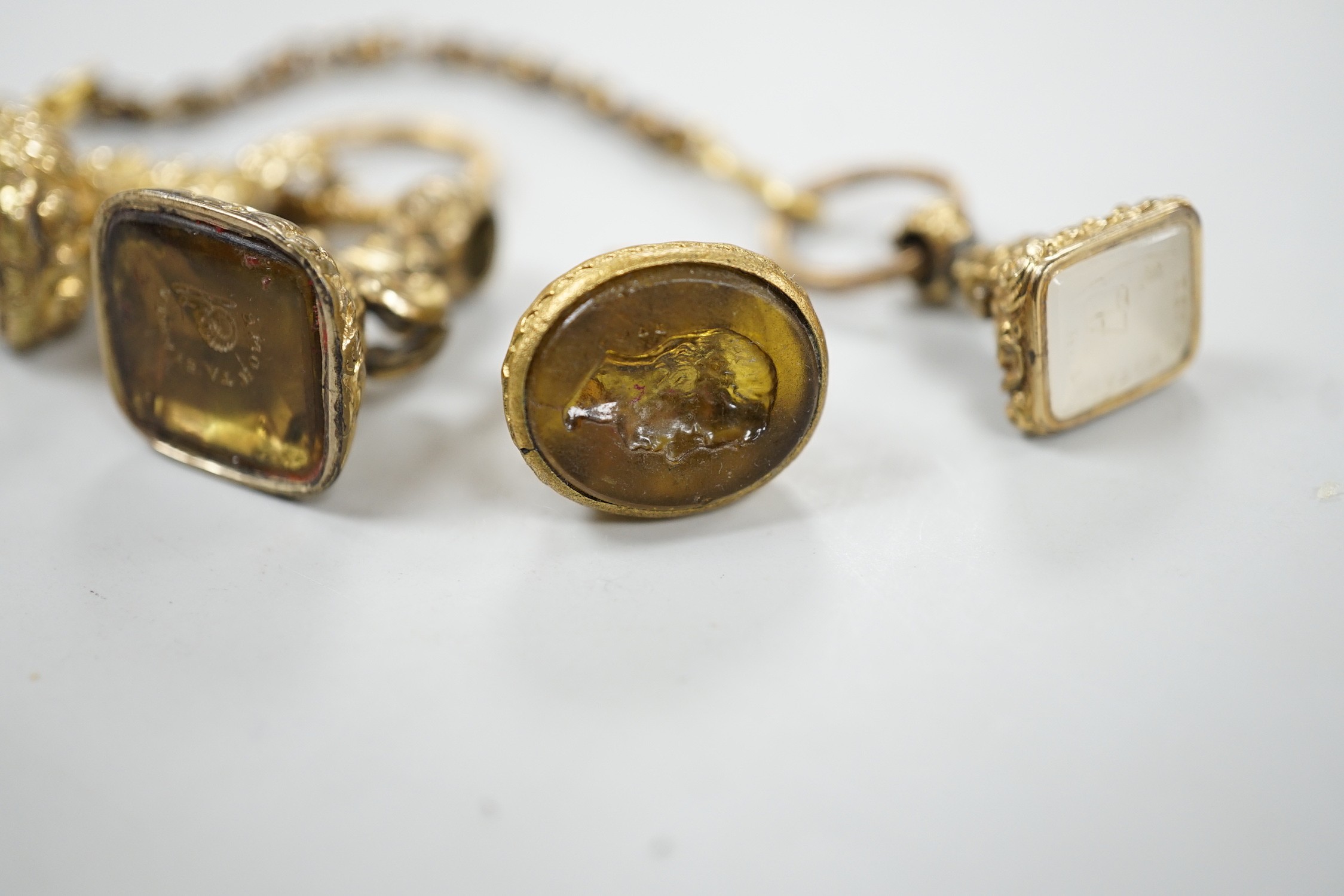 Four assorted 19th century gold plated fob seals, set with citrine, glass or carnelian, largest 30mm.